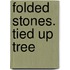 Folded stones. Tied up Tree