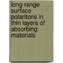 Long-range surface polaritons in thin layers of absorbing materials